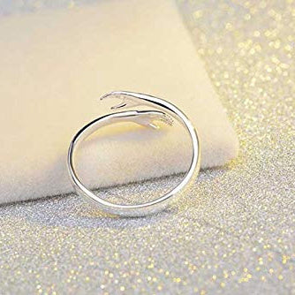 Silver ring on a glittery surface
