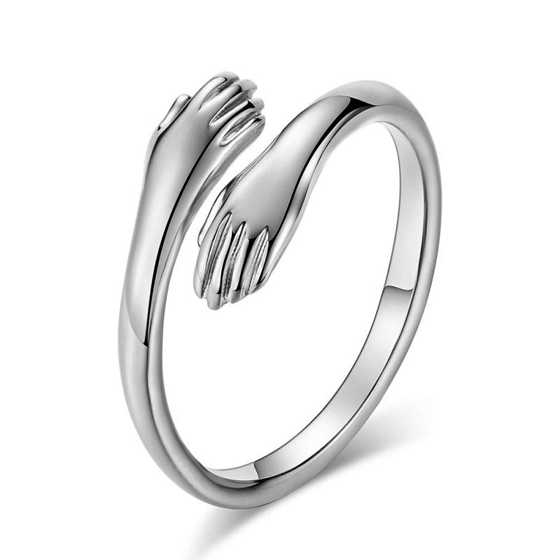 Silver ring with a hand design on a white background