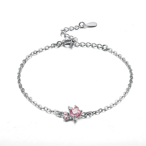 Silver bracelet with a pink heart-shaped gemstone on a white background