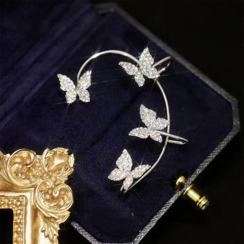 Butterfly-shaped jewelry piece on a dark fabric background