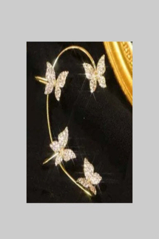 Butterfly-shaped earrings on a black background