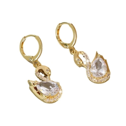 Gold earrings with teardrop-shaped clear stones on a white background