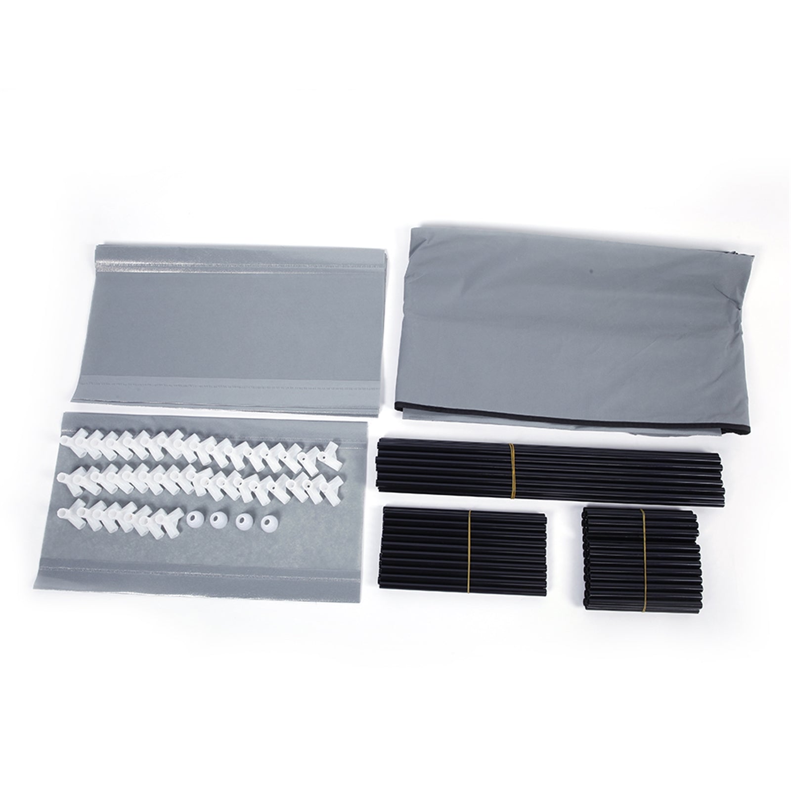 Collection of small components including screws and plastic parts in gray bags on a white background  from Nested Wisdom