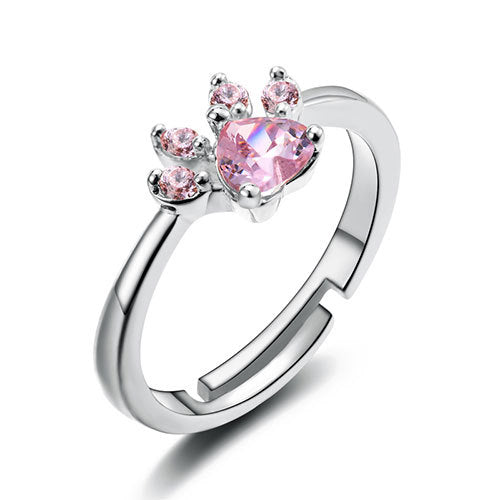 Silver ring with pink heart-shaped gemstone on a white background