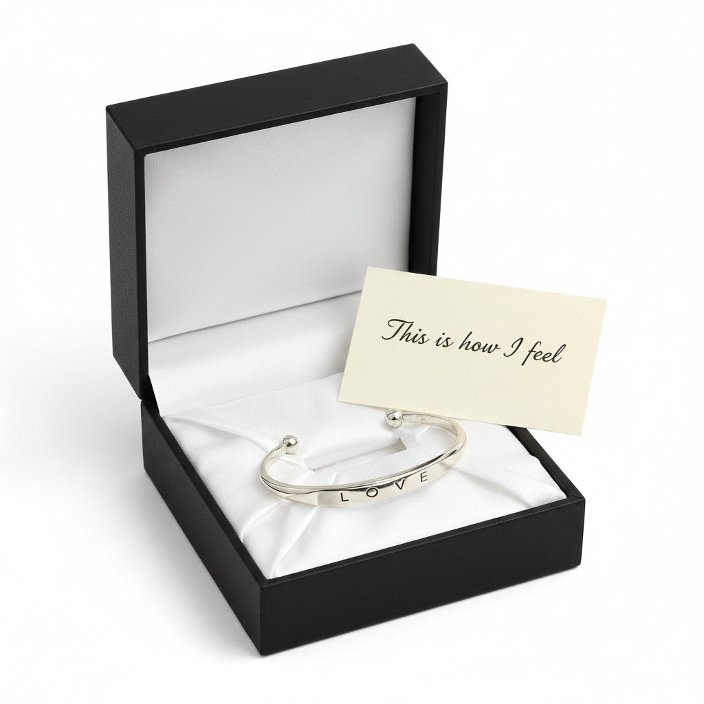 Silver bracelet with 'LOVE' engraving on a white background