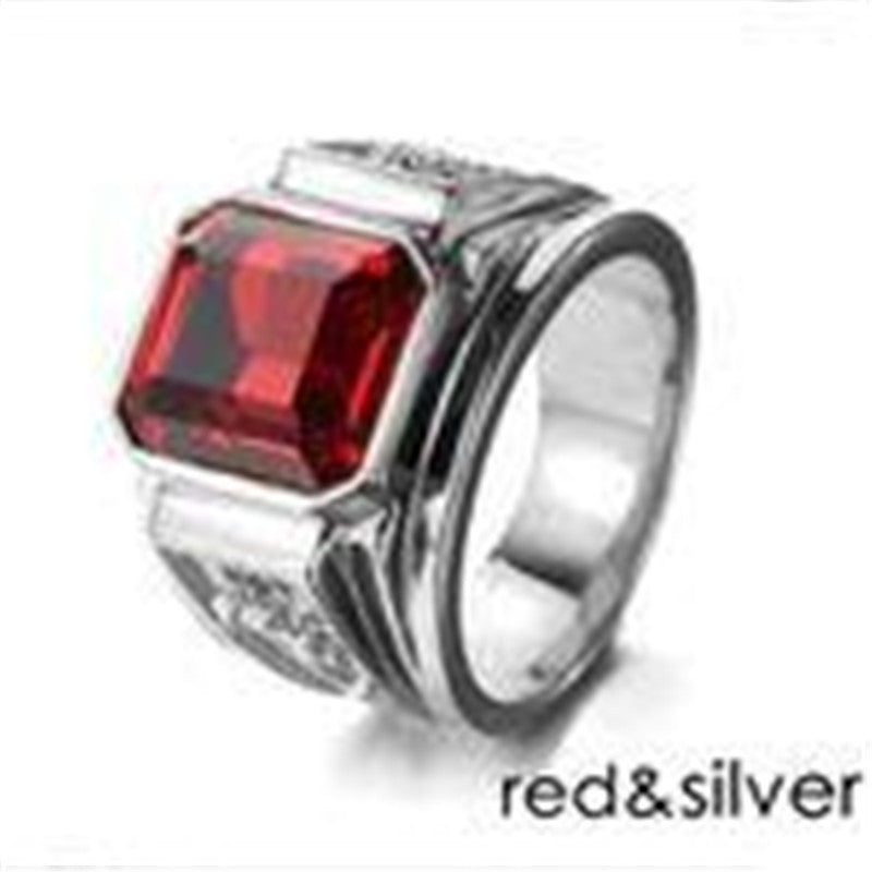 Ring with a red gemstone and silver band on a white background