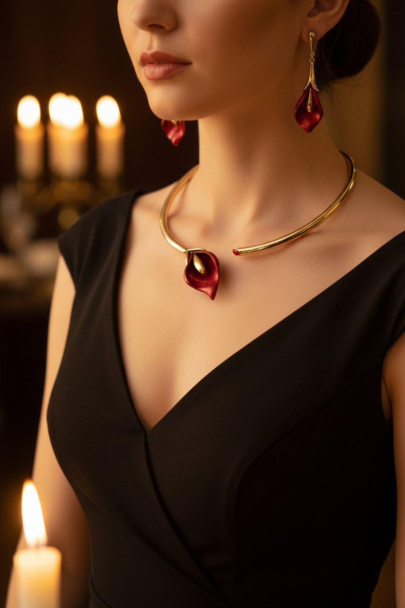 Jewelry set with red leaf-like stones on a woman wearing a black dress