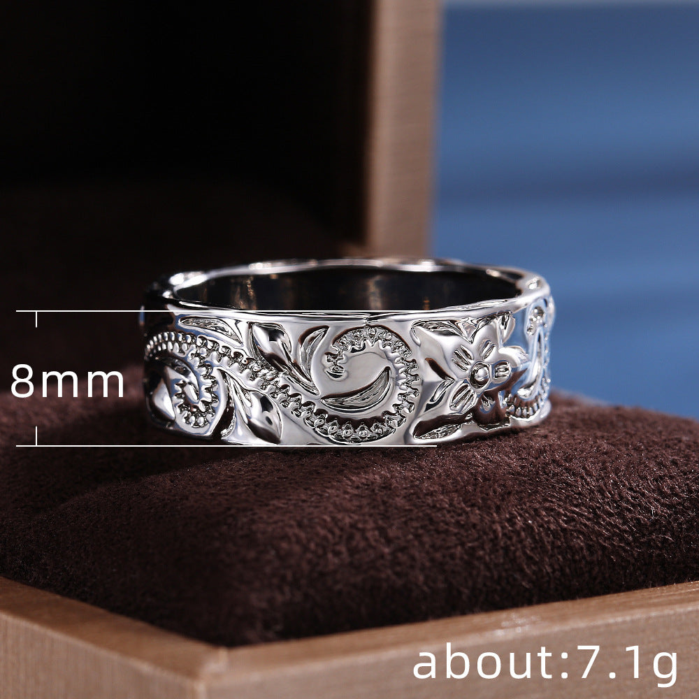 Silver ring with floral design on a brown cushion, with measurements displayed.