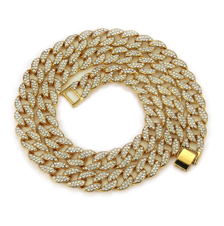 Gold chain necklace with clear stones on a white background