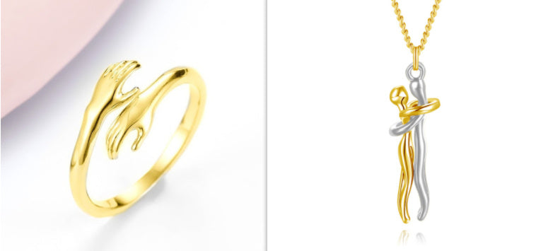 Gold ring and silver and gold pendant on a white background