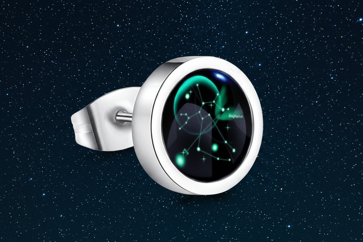 Silver ring with a black gemstone featuring green astrological design on a white background from nested wisdom