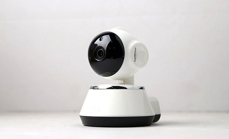 White and black security camera on a white background