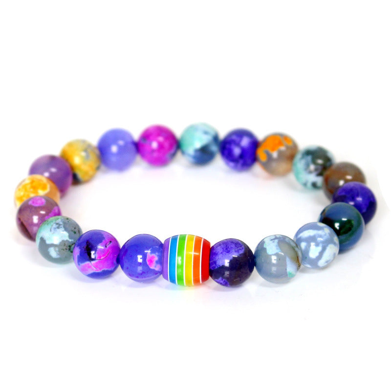 Multicolored beaded bracelet with a rainbow stripe on a white background