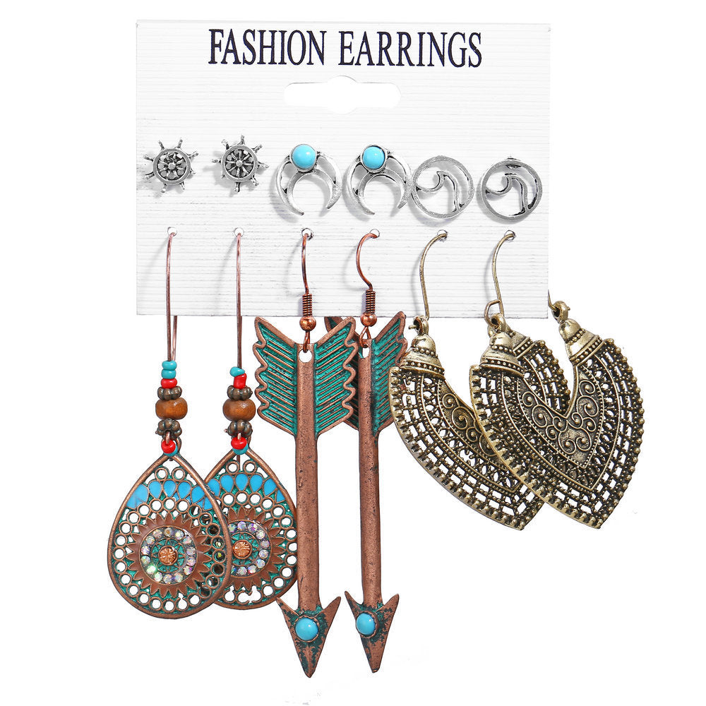 Set of fashion earrings on a display card with various designs.