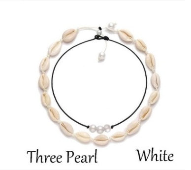 Necklace with shell beads and pearls on a white background
