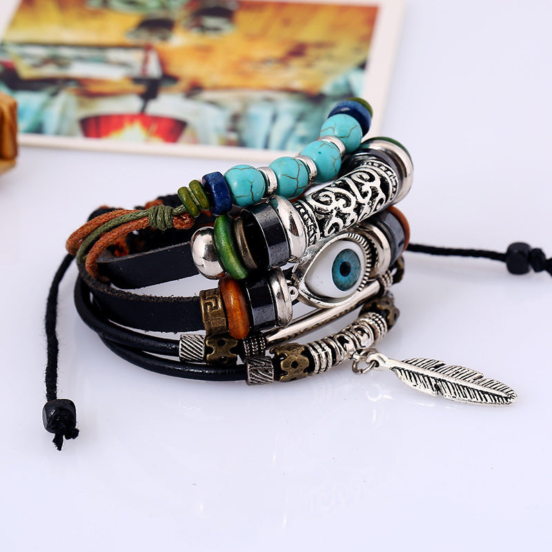 Multistrand bracelet with beads and charms on a white surface