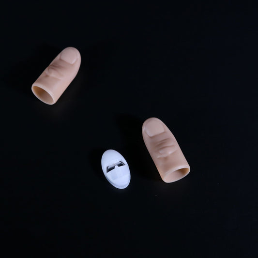 Three silicone nail tips on a black background