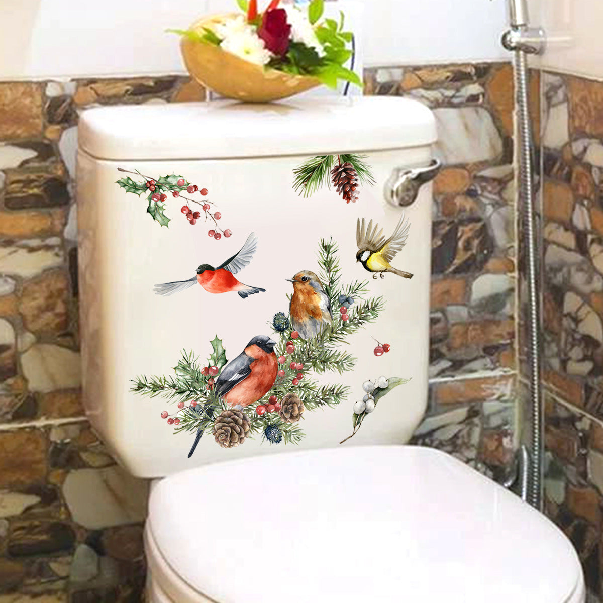 Toilet with decorative decal of birds and nature on a tiled bathroom wall.