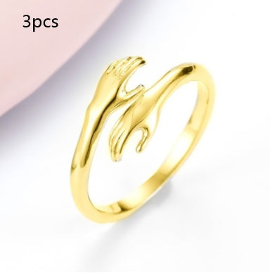 Gold ring with a wave design on a light gray background