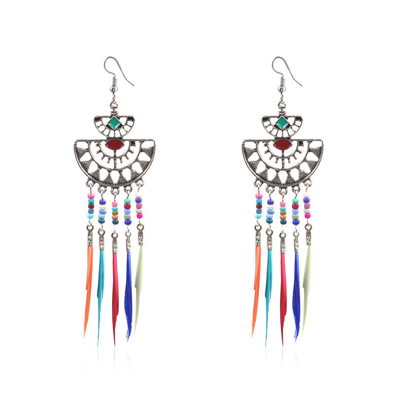 Colorful beaded earrings with feather-like tassels on a white background