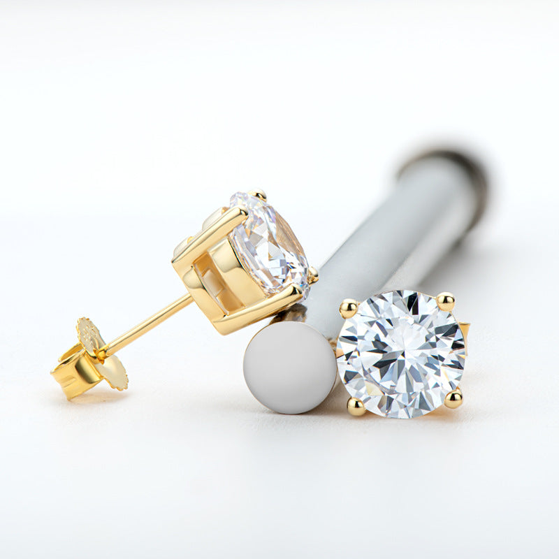 Gold earrings with clear gemstones on a white background