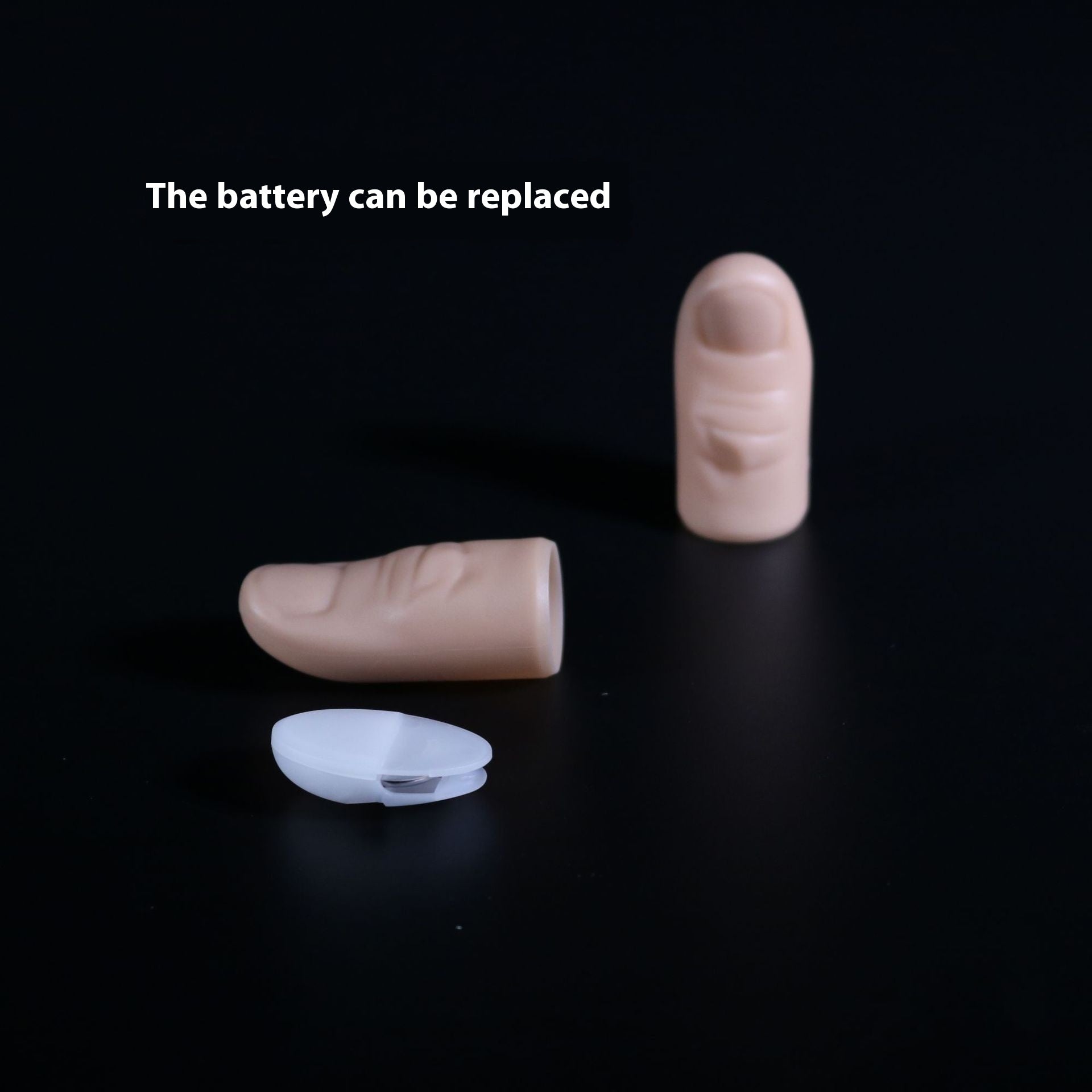 Two beige hearing aid batteries and a clear battery case on a black background with text 'The battery can be replaced'.