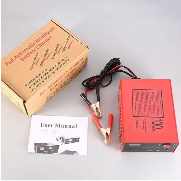 Battery charger with packaging, user manual, and cables on a gray background