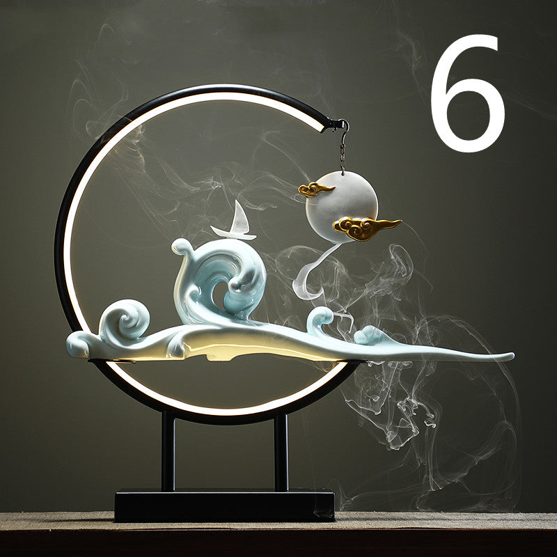 Decorative lamp with wave and cloud design on a dark background  incense burner