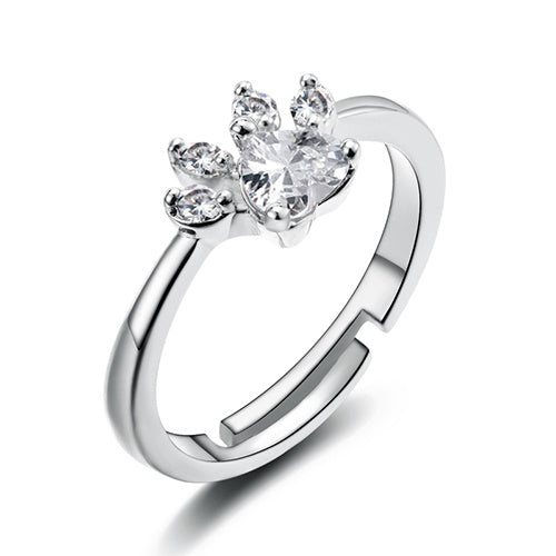 Silver ring with a heart-shaped diamond on a white background