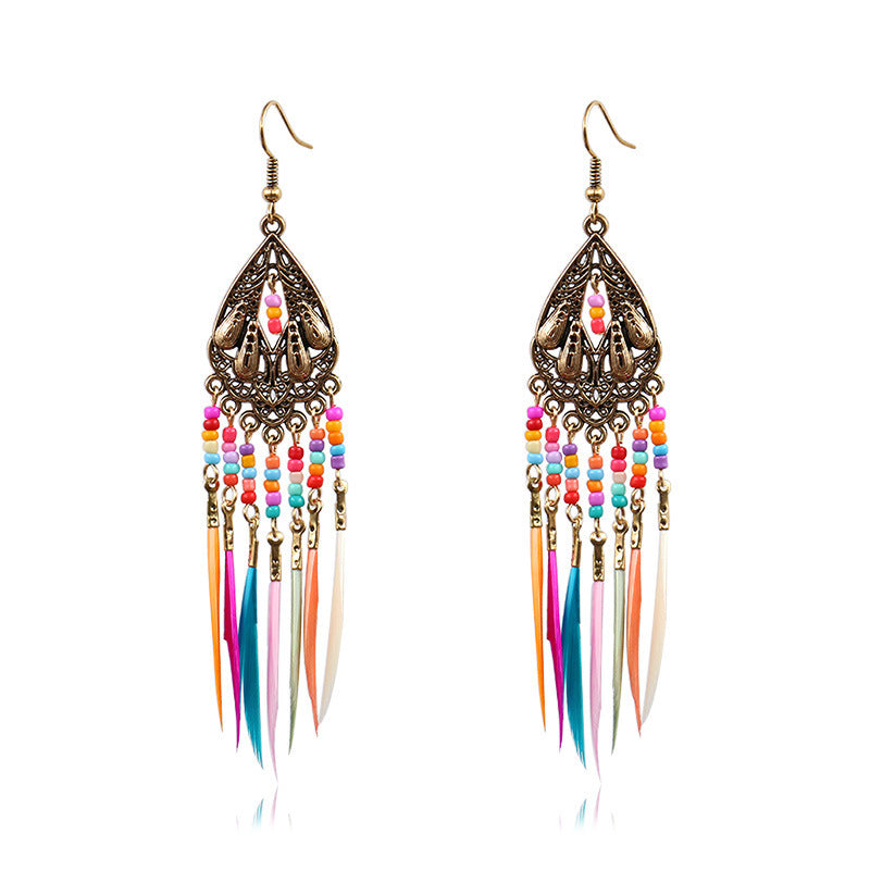 Colorful beaded earrings with feather-like tassels on a white background