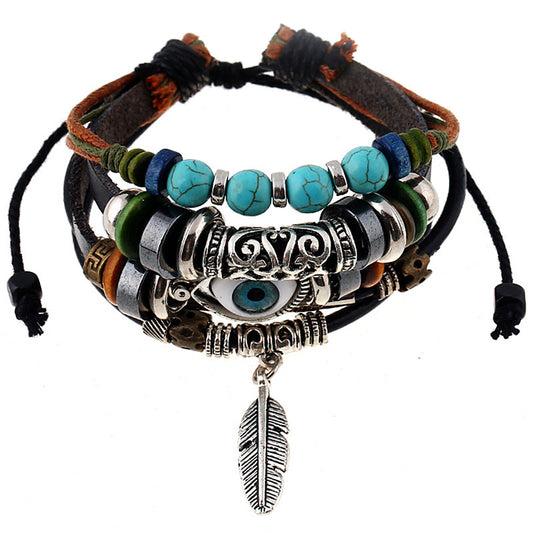 Multistrand bracelet with beads, feathers, and eye charms on a white background