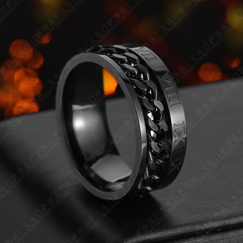 Black metal ring with intricate design on a dark background