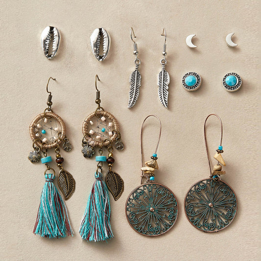 Collection of various earrings on a beige background