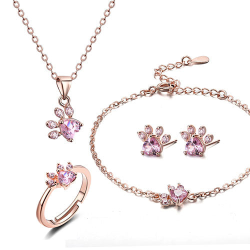 Rose gold jewelry set with pink gemstones on a white background