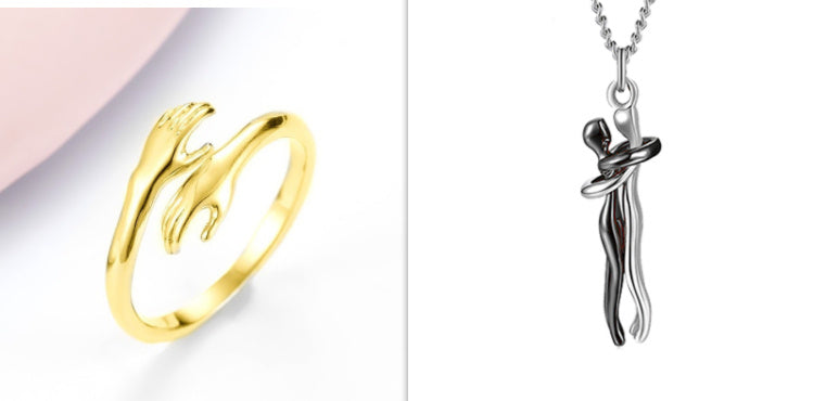 Gold ring and silver pendant on a white background
