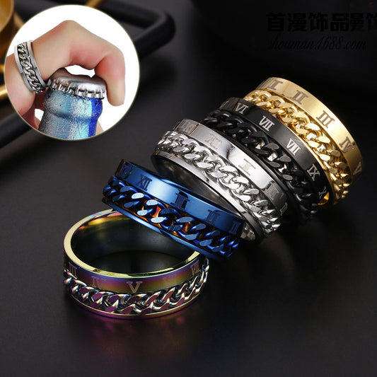 Set of metallic rings with chain designs on a dark surface