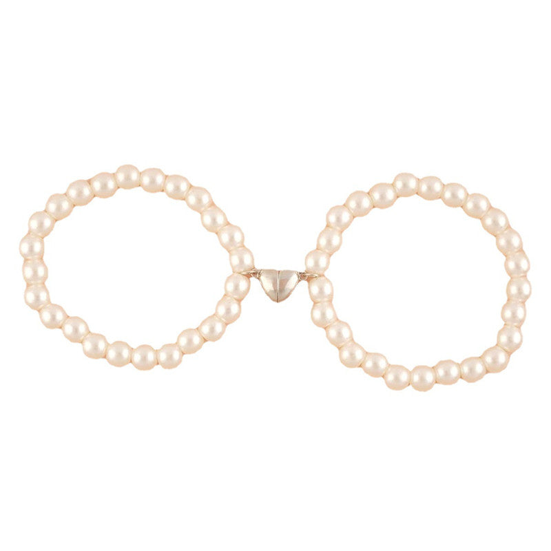 Pair of pearl hoop earrings on a white background