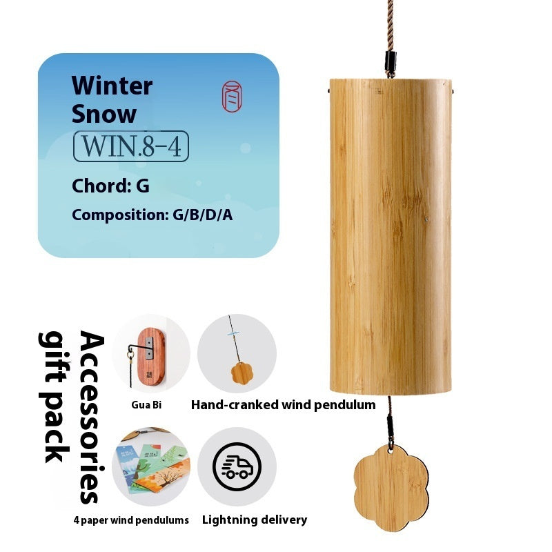 Wooden wind chime with 'Winter Snow' information and accessories on a white background