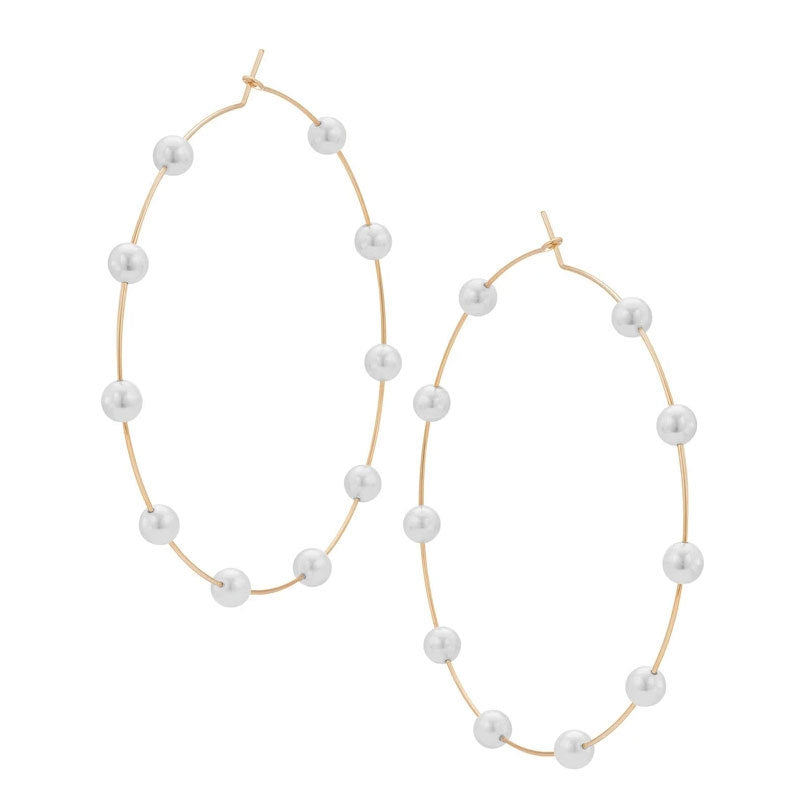 Pair of hoop earrings with pearl beads on a white background