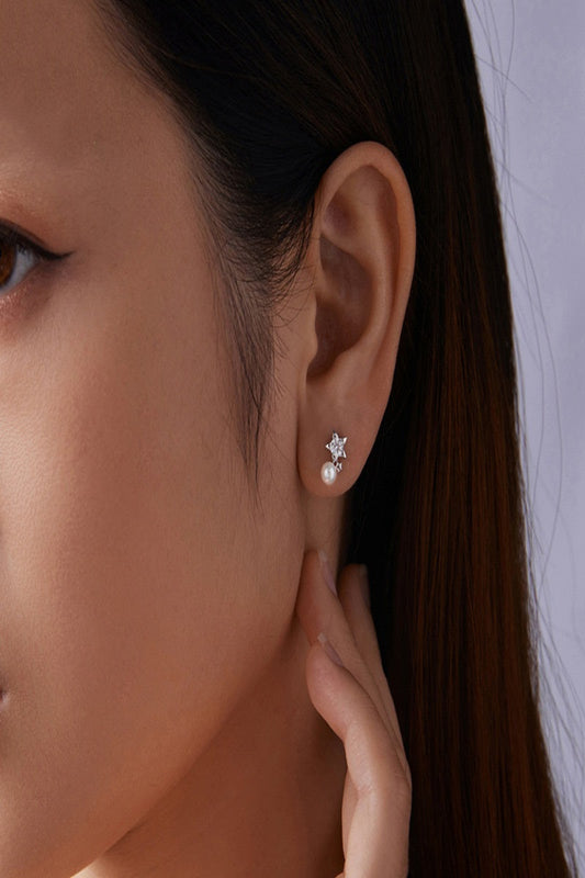 Close-up of a woman wearing a pearl earring with a blurred background