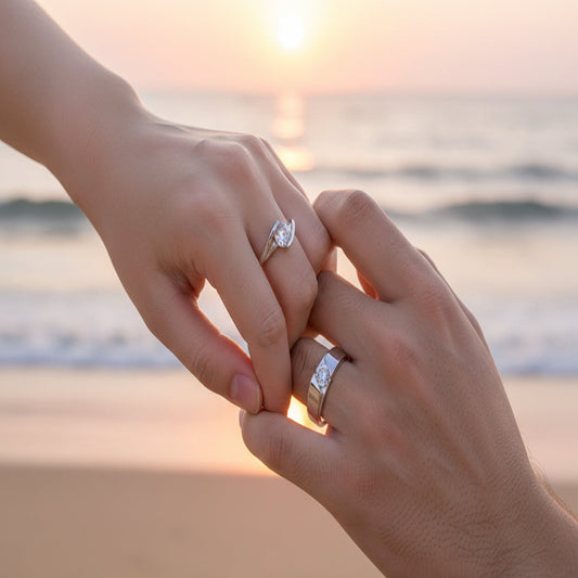Two silver rings with clear gemstones on a light background