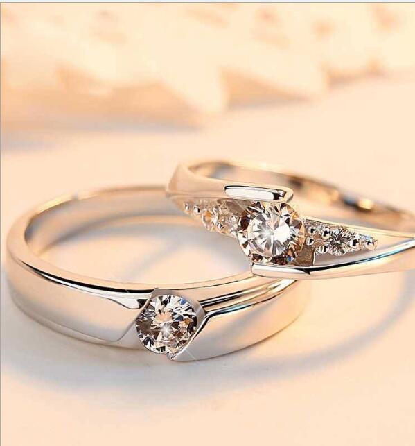 Two gold rings with diamond accents on a soft focus background