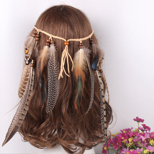Feather headband with beads on a wig against a white background