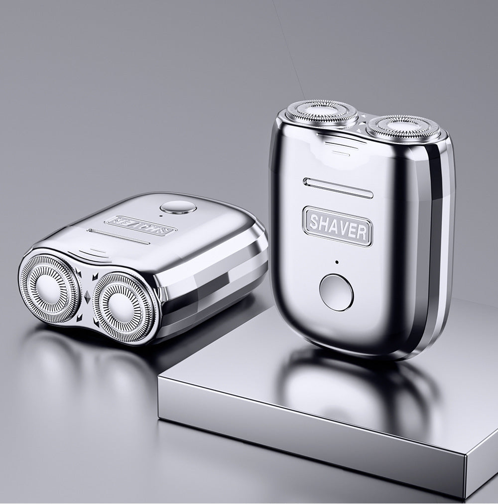 Two silver electric shavers on a reflective surface with a gray background