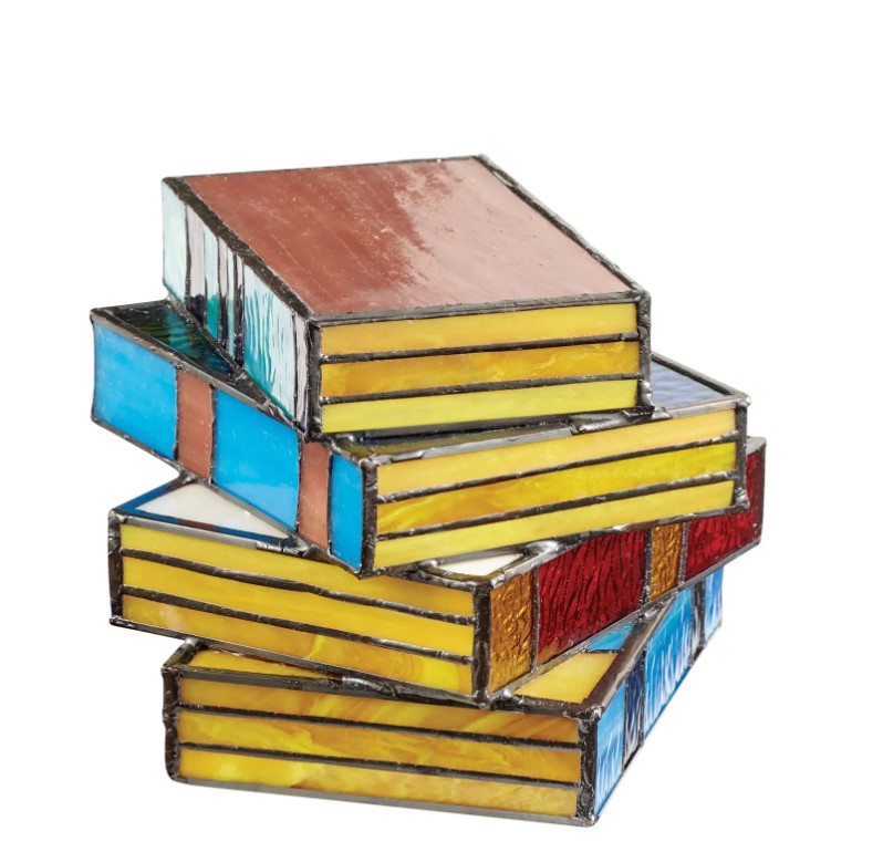 A colorful book-shaped accent lamp on a white background