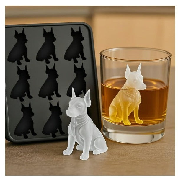Dog-shaped ice cube tray next to a glass of whiskey with a dog ice cube.
