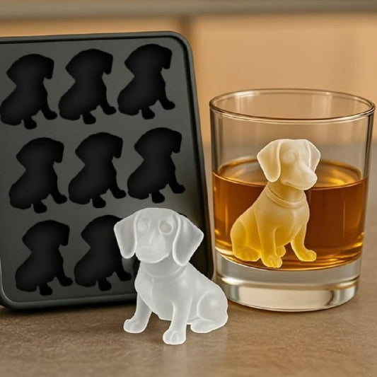 Dog-shaped ice cube tray with a glass of amber liquid and a dog ice cube.