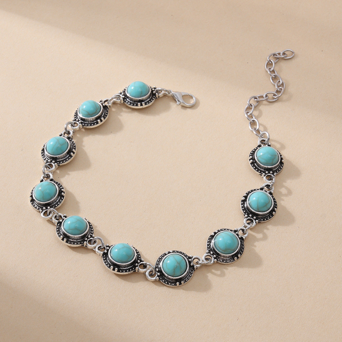 Turquoise stone bracelet on a beige background