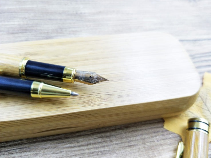 “Close-up of glossy bamboo pen body with gold-tone metal accents”