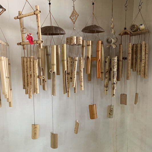 Bamboo wind chimes hanging against a light background